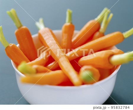 Fresh organic honey glazed baby carrots in a serving bowl Fresh organic honey glazed baby carrots in a serving bowl 95832784