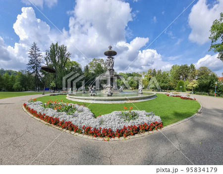 Beautiful fountain in the city park Stadtpark, a green island in the middle of the city center of Graz, Styria region, Austria. Selective focus 95834179