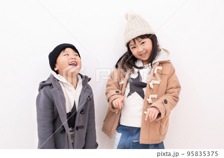 お揃いのダッフルコートとニット帽を被るアジア人の子供 95835375