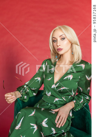 Studio photo shoot of pretty confident blonde woman in fashionable dress Studio photo shoot of pretty confident blonde woman in fashionable dress 95837168
