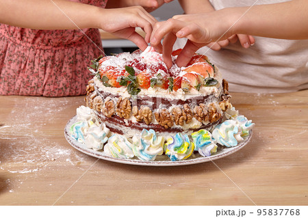 Little friends are making a cake together at a kitchen. 95837768