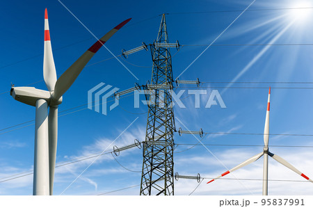 Wind Turbines and High Voltage Tower against a Blue Sky - Renewable Energy Wind Turbines and High Voltage Tower against a Blue Sky - Renewable Energy 95837991