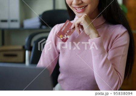 Young person using credit card and laptop computer. Online shopping, e-commerce concept Young person using credit card and laptop computer. Online shopping, e-commerce concept 95838094