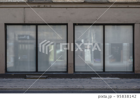Facade of a boutique shop with large windows and a place for a name. Closed shop. Facade of a boutique shop with large windows and a place for a name. Closed shop. 95838142
