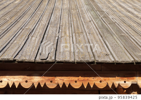 Gray wooden roof slope with decorative cornice 95839425