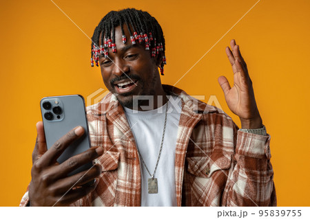 Young african man using smartphone over isolated yellow background 95839755