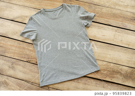 Blank grey t-shirt on wooden background top view Blank grey t-shirt on wooden background top view 95839823