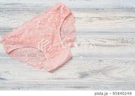 Top view women's underwear panties on a wooden background. 95840249