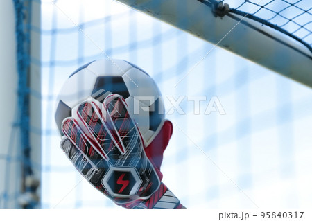 サッカーボールをキャッチするゴールキーパーの男性 95840317