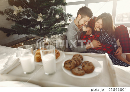 People at home. Family in a pajamas. Milk and croissants on a tray. People at home. Family in a pajamas. Milk and croissants on a tray. 95841004
