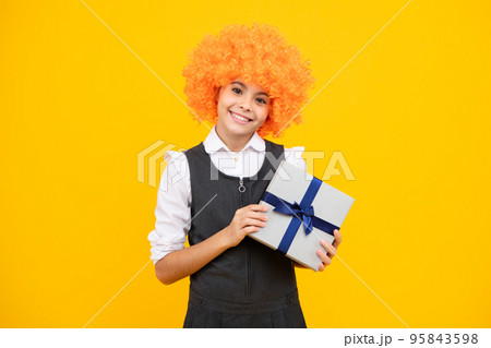Child teen girl 12-14 years old with gift on isolated background. Birthday, holiday concept. Teenager hold present box. Happy girl face, positive and smiling emotions. Child teen girl 12-14 years old with gift on isolated background. Birthday, holiday concept. Teenager hold present box. Happy girl face, positive and smiling emotions. 95843598