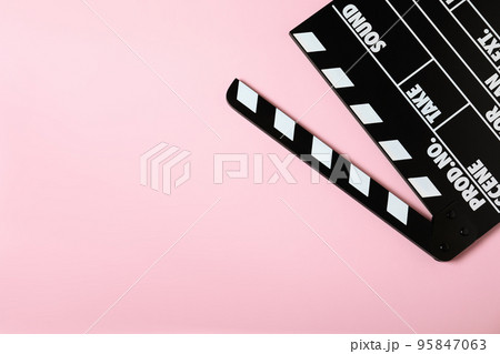 Clapper board on pink background, top view with space for text. Cinema production 95847063