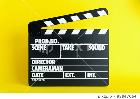 Clapper board on yellow background. Cinema production Clapper board on yellow background. Cinema production 95847064