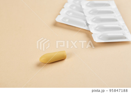 Suppositories on beige background, closeup view. Hemorrhoid treatment 95847188