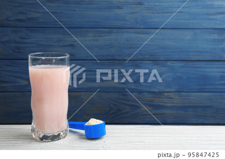 Protein shake and powder on white wooden table, space for text Protein shake and powder on white wooden table, space for text 95847425