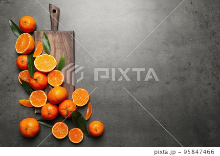 Fresh ripe tangerines and space for text on dark grey table, flat lay. Citrus fruit Fresh ripe tangerines and space for text on dark grey table, flat lay. Citrus fruit 95847466
