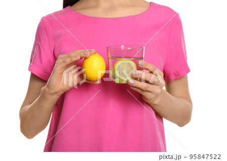 Woman with tasty lemon water and fresh fruit on white background, closeup 95847522