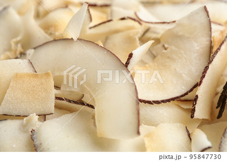 Delicious fresh coconut chips as background, closeup Delicious fresh coconut chips as background, closeup 95847730