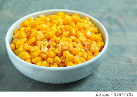 Tasty canned sweet corn on blue wooden table, closeup 95847805