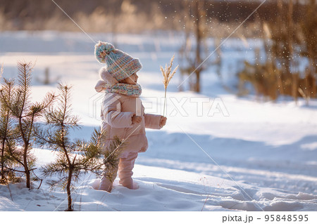 Charming little girl in a warm coat. 95848595
