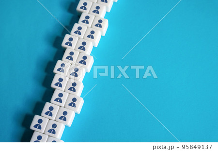 A chain of blocks of workers on a blue background. Place for text. Copyspace. Help wanted. Hiring new employees for vacancies. Human resources and work force. Staffing and recruiting candidates A chain of blocks of workers on a blue background. Place for text. Copyspace. Help wanted. Hiring new employees for vacancies. Human resources and work force. Staffing and recruiting candidates 95849137