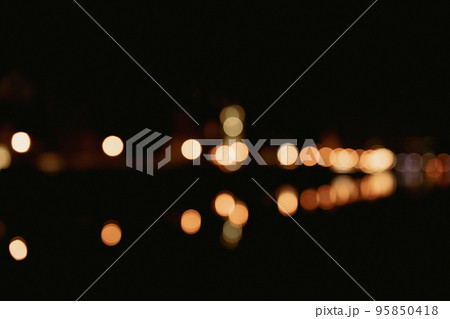 Defocused street lamps and reflection on a water, night city life. Gdansk, Poland, Europe 95850418