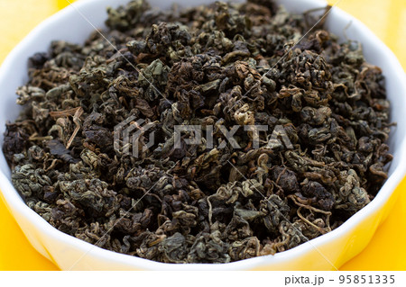 Dried Jiaogulan on yellow background. Dried Jiaogulan on yellow background. 95851335