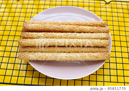 Bread sticks on yellow background Bread sticks on yellow background 95851770