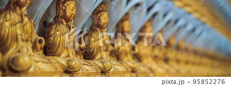 The wall in the temple is filled with buddhas. Religion Buddhism concept. Texture, background Buddhism BANNER long format The wall in the temple is filled with buddhas. Religion Buddhism concept. Texture, background Buddhism BANNER long format 95852276