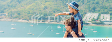 Father and son in the background of Promthep cape and Yanui beach. Phuket, Thailand. Traveling with children concept BANNER, long format 95852887