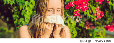 Pollen allergy concept. Young woman is going to sneeze. Flowering trees in background BANNER, long format Pollen allergy concept. Young woman is going to sneeze. Flowering trees in background BANNER, long format 95853466