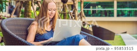 Young female freelancer sitting near the pool with her laptop in the hotel browsing in her smartphone. Busy at holidays. Distant work concept. Copy space for your text BANNER, long format 95853515