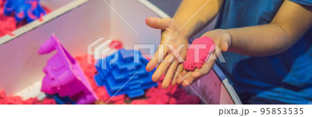 Boy playing with kinetic sand in preschool. The development of fine motor concept. Creativity Game concept BANNER, long format Boy playing with kinetic sand in preschool. The development of fine motor concept. Creativity Game concept BANNER, long format 95853535