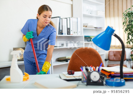 Woman cleaning floor with mop 95856295