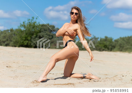 Sexual woman in bikini panties on beach 95858991