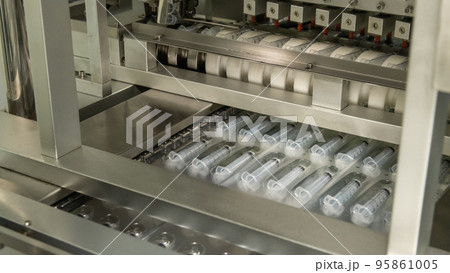 A closeup of the production of medical syringes A closeup of the production of medical syringes 95861005