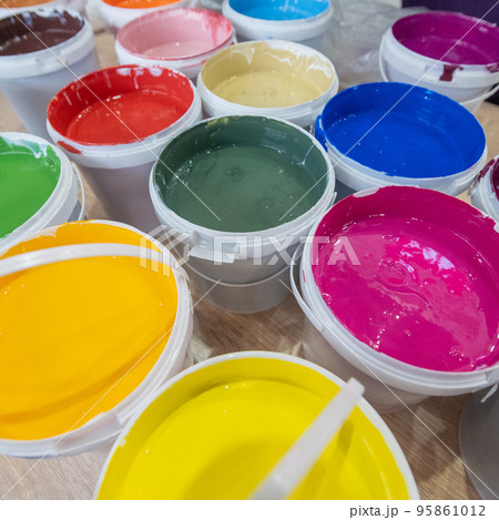 A closeup shot of buckets of colorful paint in a warehouse 95861012