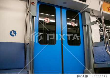 The doors in the subway car are blue 95863345