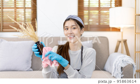 Beautiful housewife is cleaning things and vases in the living room, Big cleaning, Housework, Daily routine ,Removes germs and dirt and deep stains, Spray alcohol, Clean up on weekends. Beautiful housewife is cleaning things and vases in the living room, Big cleaning, Housework, Daily routine ,Removes germs and dirt and deep stains, Spray alcohol, Clean up on weekends. 95863614