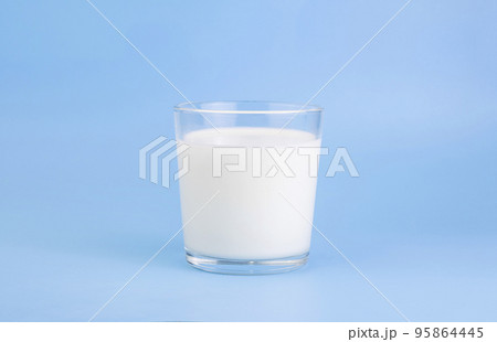 Fresh farm milk, fermented milk product, in a glass cup, on a holoumny background. Selective focus. Copy space 95864445