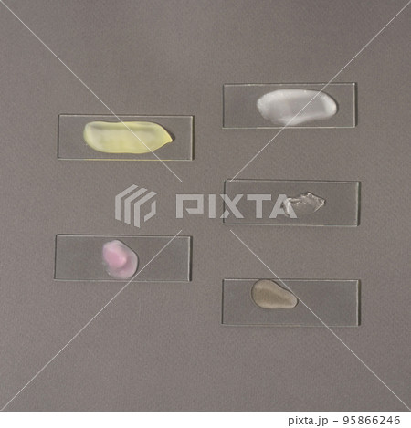 Smears of cosmetic products for the face on laboratory glass 95866246