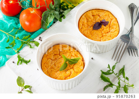 Vegetarian vitamin breakfast French baked cheese souffle with tomato  on a wooden table. Vegan dish. Proper nutrition. Healthy lifestyle. 95870263