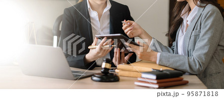 Asian business team and lawyers discussing contract papers sitting at the table. Concepts of law, advice, legal services. at office 95871818