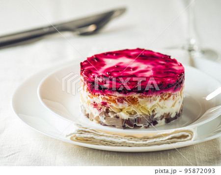 Salad herring under fur coat on festive plate 95872093
