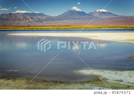 Volcanic landscape and salt lake reflection at sunset in Atacama Desert, Chile 95874371