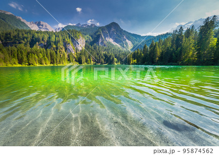 Lake Tovel reflection symmetry in Trentino-Alto Adige, Dolomites, Italy Lake Tovel reflection symmetry in Trentino-Alto Adige, Dolomites, Italy 95874562