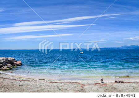 Idyllic lake Garda coastline in Lazise with boat, Northern Italy Idyllic lake Garda coastline in Lazise with boat, Northern Italy 95874941