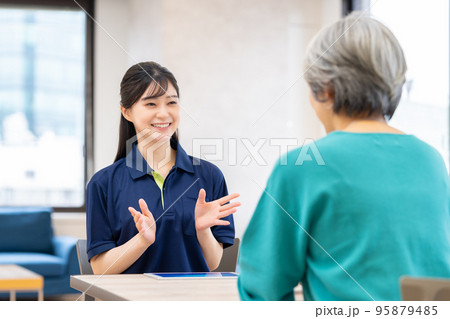 シニアの女性に説明するケアマネージャー シニアの女性に説明するケアマネージャー 95879485