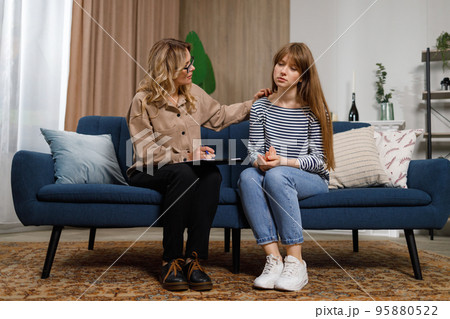 Shot of a young woman having a therapeutic session with a psychologist 95880522