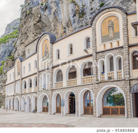 Monastery of Ostrog, Serbian Orthodox Church situated against a vertical background, high up in the large rock of Ostroska Greda, Montenegro. Dedicated to Saint Basil of Ostrog 95880868